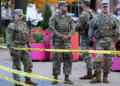 National Guard members stand together behind yellow tape, after two National Guard members were shot near the White House in Washington, DC, US on November 26. — Reuters