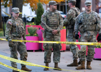 National Guard members stand together behind yellow tape, after two National Guard members were shot near the White House in Washington, DC, US on November 26. — Reuters