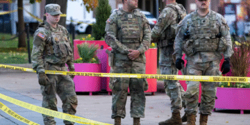 National Guard members stand together behind yellow tape, after two National Guard members were shot near the White House in Washington, DC, US on November 26. — Reuters