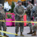 National Guard members stand together behind yellow tape, after two National Guard members were shot near the White House in Washington, DC, US on November 26. — Reuters