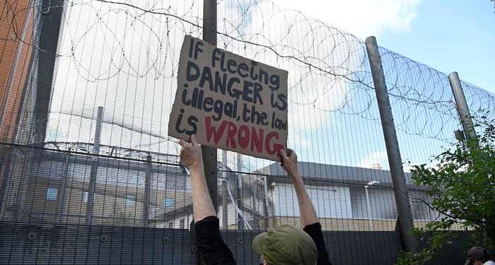 Demonstrators protest outside of Brook House Immigration Removal Centre against a planned deportation of asylum seekers from Britain to Rwanda, at Gatwick Airport near Crawley, Britain.— Reuters