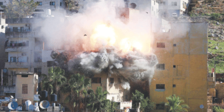Smoke billows as Israeli forces demolish the house of Abdul Karim Snobar, who was detained earlier this year after being accused of plotting bus bombings in the occupied West Bank city of Nablus.—AFP