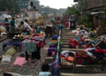 KANDY: People affected by floods in Sri Lanka collect their belongings from the railway tracks after drying them.—Reuters