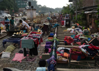 KANDY: People affected by floods in Sri Lanka collect their belongings from the railway tracks after drying them.—Reuters