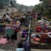 KANDY: People affected by floods in Sri Lanka collect their belongings from the railway tracks after drying them.—Reuters