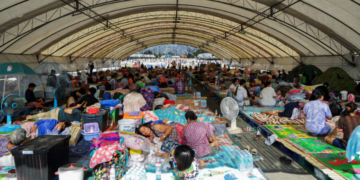 People rest at a shelter, following fresh military clashes between Thailand and Cambodia along parts of their disputed border, in Buriram province, Thailand
