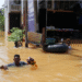 People wade through a flooded street, following Cyclone Ditwah in Kelaniya, Sri Lanka [Thilina Kaluthotage/Reuters]