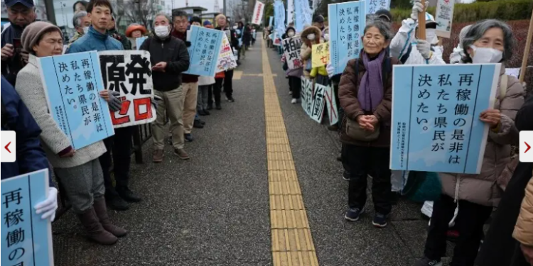 Protesters take part in a rally near Niigata prefectural government office building before voting takes place in the prefectural assembly on a partial restart of the Tokyo Electric Power Company’s (TEPCO) in Niigata, Japan on December 22, 2025. — Reuters