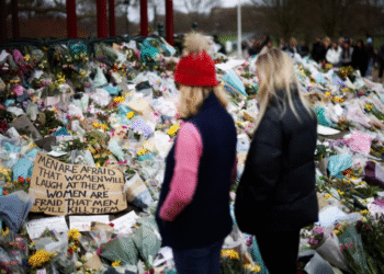 People observe a memorial site at the Clapham Common Bandstand, following the kidnapping and murder of Sarah Everard, in London, Britain, March 21, 2021. REUTERS
