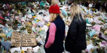 People observe a memorial site at the Clapham Common Bandstand, following the kidnapping and murder of Sarah Everard, in London, Britain, March 21, 2021. REUTERS