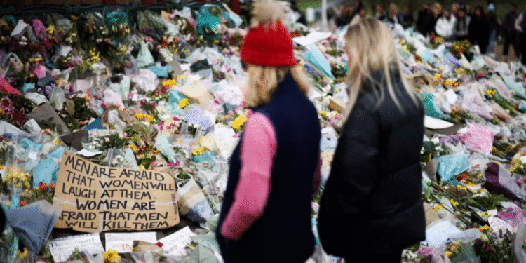 People observe a memorial site at the Clapham Common Bandstand, following the kidnapping and murder of Sarah Everard, in London, Britain, March 21, 2021. REUTERS