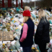 People observe a memorial site at the Clapham Common Bandstand, following the kidnapping and murder of Sarah Everard, in London, Britain, March 21, 2021. REUTERS