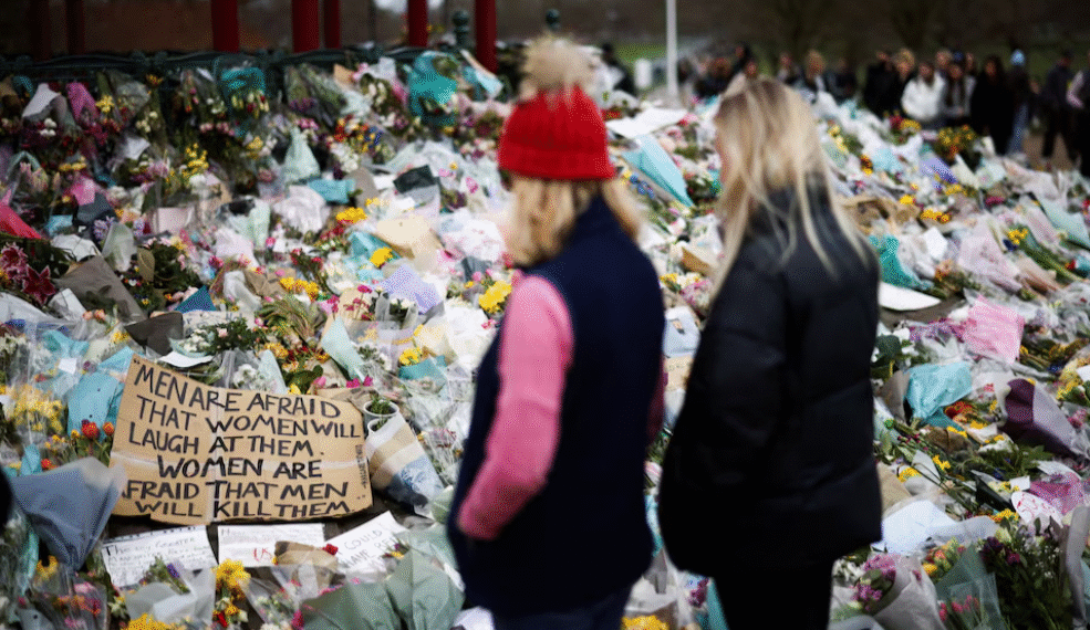 People observe a memorial site at the Clapham Common Bandstand, following the kidnapping and murder of Sarah Everard, in London, Britain, March 21, 2021. REUTERS