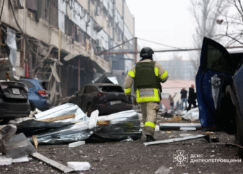 A rescuer walks at the site of a midday Russian missile strike, amid Russia's attack on Ukraine, in Dnipro, Ukraine