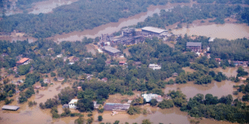 An aerial view of submerged buildings in a flooded area caused by heavy rainfall following Cyclone Ditwah in Niyamgamdora, Sri Lanka