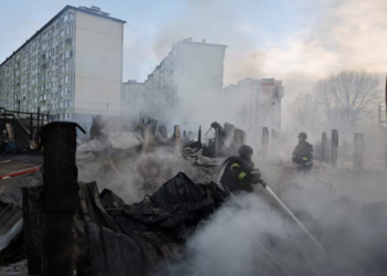 Emergency responders work at the site of a warehouse that was struck during a night of Russian missile and drone strikes, amid Russia's attack on Ukraine, in Novi Petrivtsi, outside Kyiv, Ukraine, December 6, 2025. REUTERS