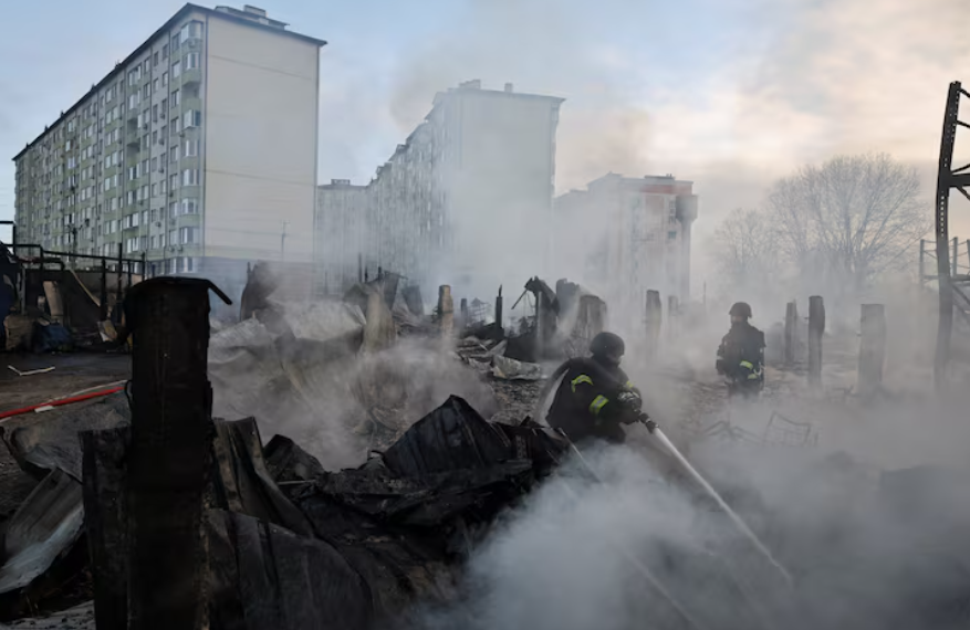 Emergency responders work at the site of a warehouse that was struck during a night of Russian missile and drone strikes, amid Russia's attack on Ukraine, in Novi Petrivtsi, outside Kyiv, Ukraine, December 6, 2025. REUTERS